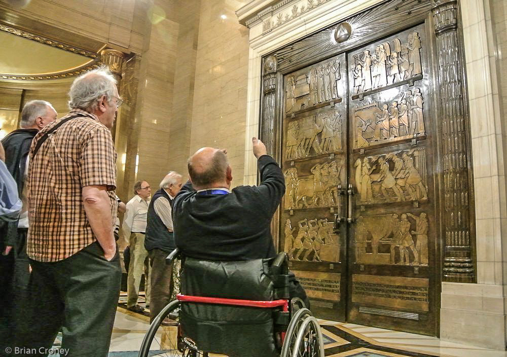 Our guide describes the heavy doors to the temple