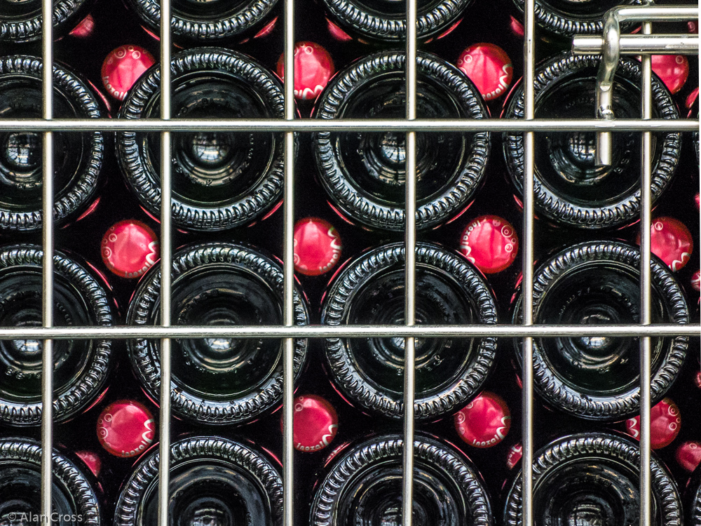 Sparkling wine with its temporary caps, in a turning cage.