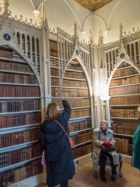 Alixe showing how the books behind the Gothic façade could be accessed