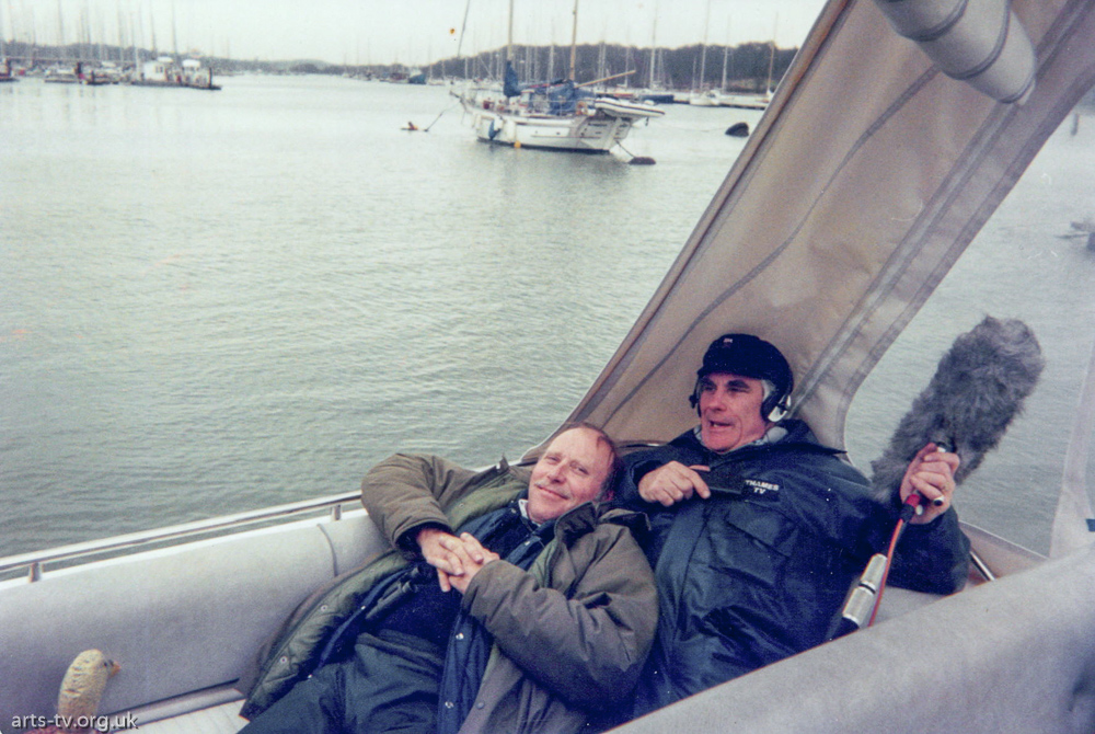 Mike Hobbs, Tony Field recline in boat on location