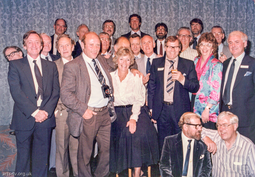 Group posing at dressy function. Bill Smith standing tallest in back row, Ted Flake, John Hamilton. Middle row 2nd from left Doug Rowlands, Jim Pople, Steve Minchin, Bill Sutton, Peter Bond, Jill Baldry, John McAdam.  Front: Mike Hobbs, unknown lady, Dick Dale. Kneeling in front:  Charley Warren, Don Chapman
