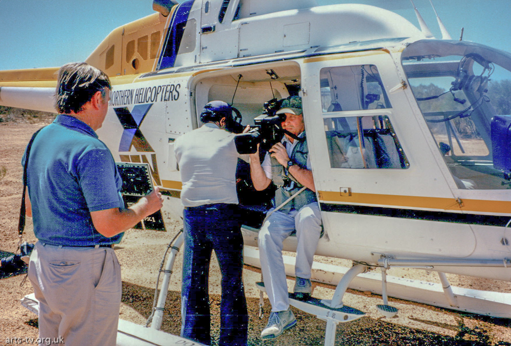 Mike Hobbs with camera strapped into helicopter, door open “WYWH” Western Australia