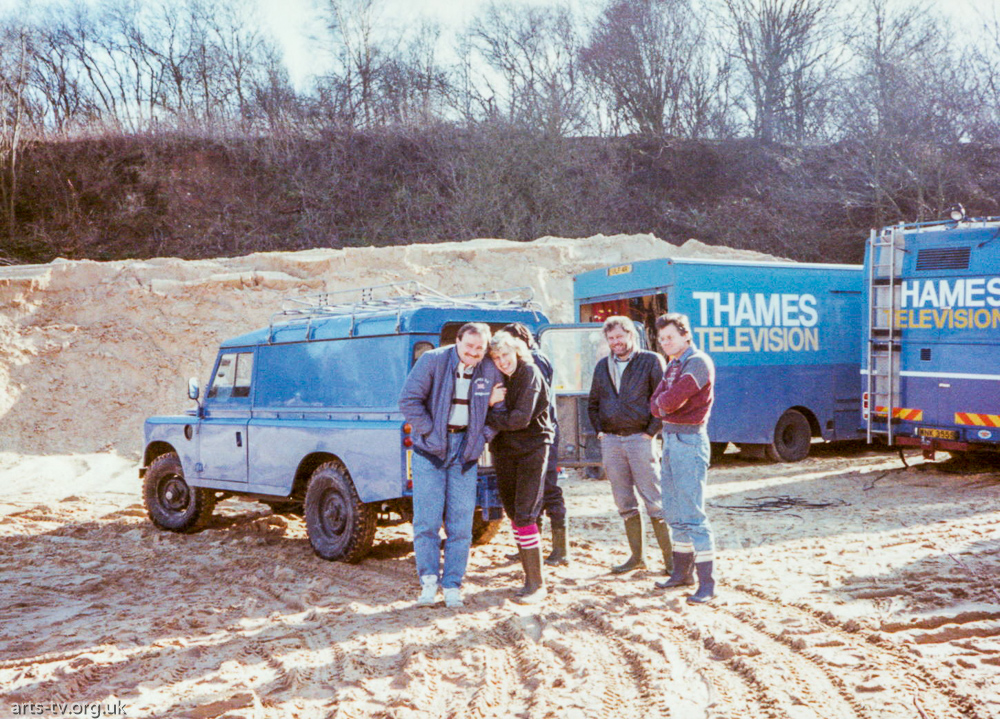 Cherry Crompton hugging Keith Thomas (OB VTR), Andy Newton, Chris O’Dell (OB Engineer) on location in quarry (?), scanners b/g